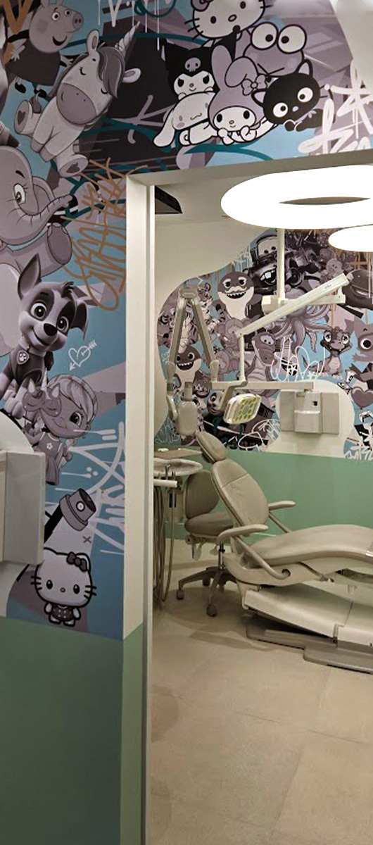 Custom cartoon wall mural installed in a modern dental clinic interior
