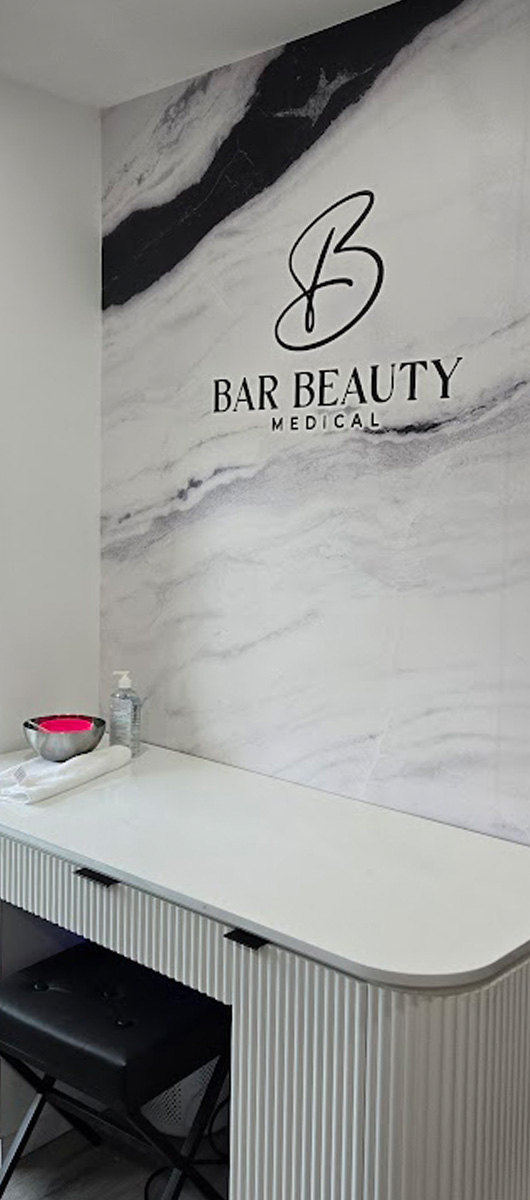 Custom marble wall mural with logo installed in beauty clinic interior