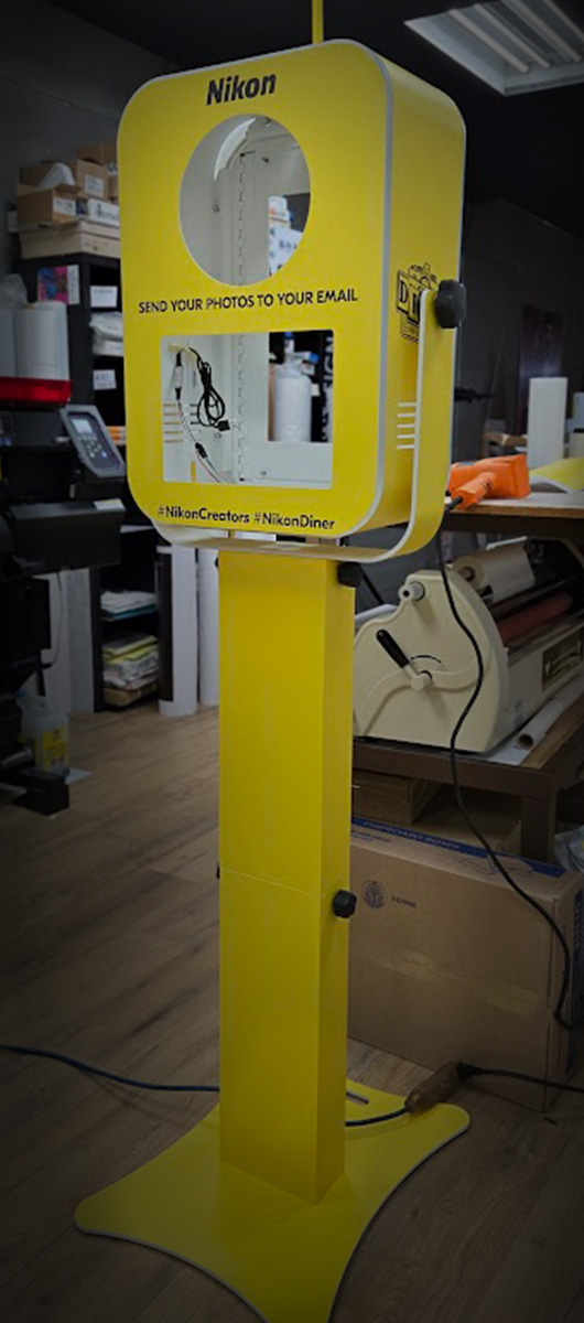 Custom vinyl wrap for promotional photo booth kiosk with branded graphics and smooth matte finish in Toronto GTA