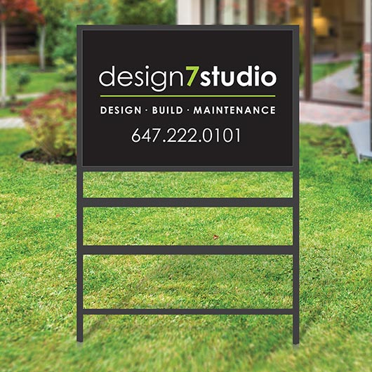 Large metal frame lawn sign with custom printed panel installed on a front yard for real estate or business advertising