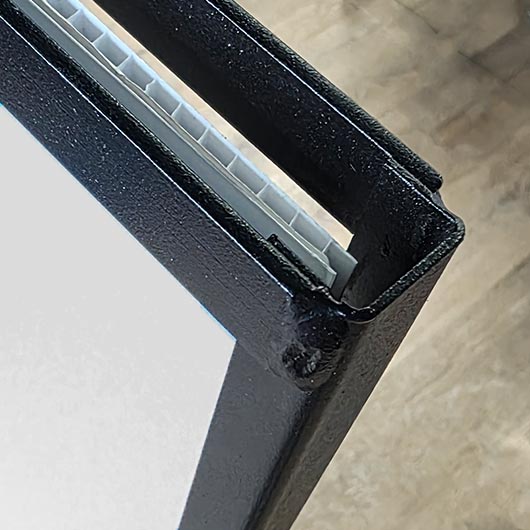 Close-up of metal frame lawn sign showing the coroplast panel inserted into the frame channel