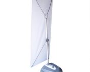 Outdoor X-banner stand with water-filled base and vertical banner display for sidewalk and event advertising