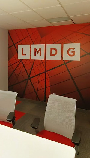 Custom branded wall mural installed in modern office meeting room