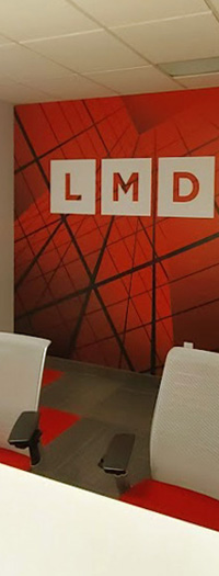 Custom branded wall mural installed in modern office meeting room Custom branded wall mural installed in modern office meeting room