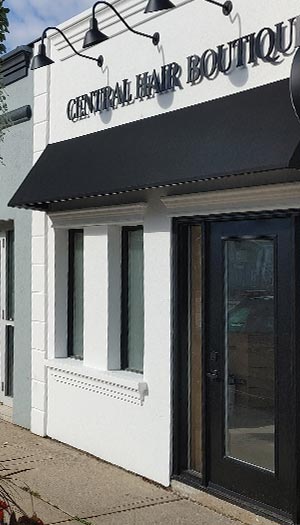 Black fabric storefront awning installed above boutique entrance