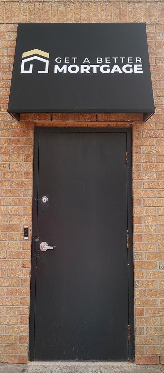 Black metal storefront awning with logo above commercial entrance