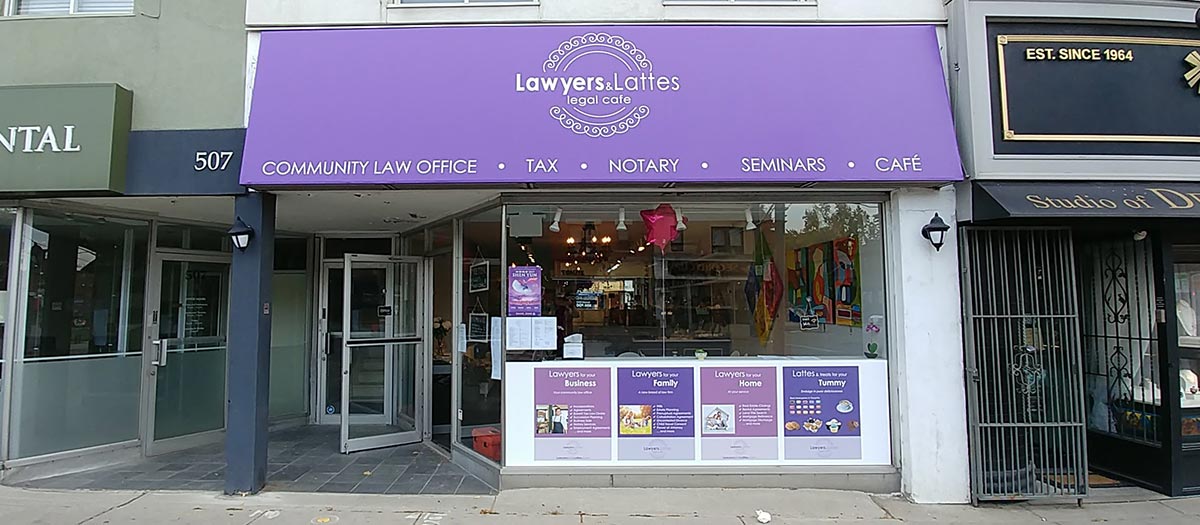 Custom purple storefront awning with printed logo above café and legal office entrance